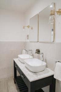 a bathroom with two sinks and a mirror at Highfield Hall in Mold