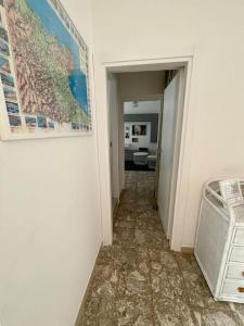 a hallway with a map on the wall and a basket at Home by the sea in Manfredonia