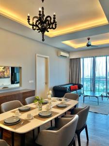 a dining room with a table and chairs at LUXURY 3BR Penthouse I The Shore Hotel & Residence I Seaview I Poolview I 6-9Pax in Melaka