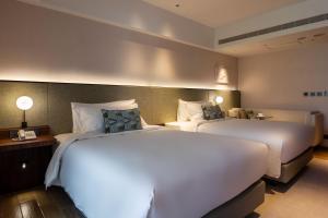 Ένα ή περισσότερα κρεβάτια σε δωμάτιο στο Kilin Hotel, JiaoXi