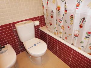 a bathroom with a toilet and a shower curtain at Apartamentos Benicarló 3000 in Benicarló +35 photos