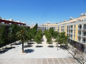 a courtyard in a building with palm trees and buildings at Apartamentos Benicarló 3000 in Benicarló