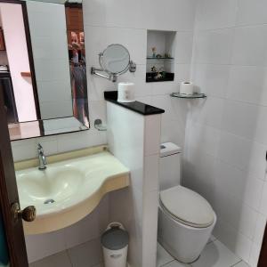 a bathroom with a sink and a toilet and a mirror at Bungalows Musch Kamala Phuket in Kamala Beach