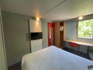 - une chambre avec un lit, un bureau et une fenêtre dans l'établissement ibis Epinal Centre, à Épinal