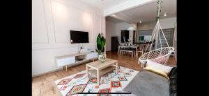 a living room with a couch and a dining room at City Retreat at Quintet(3BR/8pax) 9 Jalan PMCJ, Tanah Rata in Tanah Rata