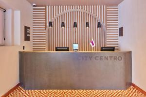 a lobby of a city centro with a reception desk at City Centro by Marriott Oaxaca in Oaxaca City