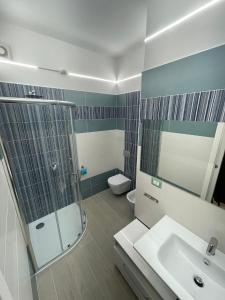 uma casa de banho com um chuveiro, um lavatório e um WC. em Residence Bandiera Blu em Diamante