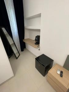 a small room with a table and a black box at Residence Bandiera Blu in Diamante