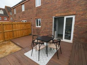a patio with two chairs and a table on a deck at 39 Mariners Quay in Port Talbot