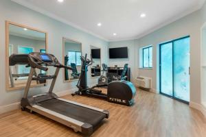 a gym with two treadmills and two exercise bikes at Best Western Plus All Suites Inn in Santa Cruz