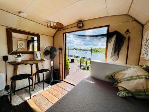an interior view of a caravan with a view of the water at Wake nams ar pirtiņu in Jēkabpils