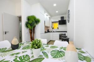 a white room with a table with plants on it at Beach Way Apartment in Lagos