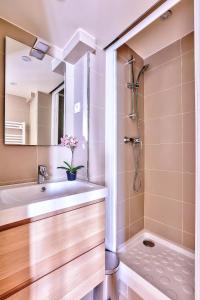 a bathroom with a sink and a shower at St Michel - Deluxe Apartment - Harpe in Paris