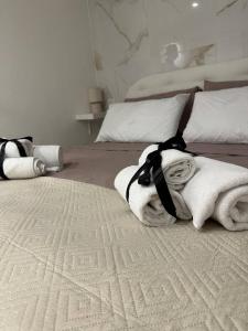 a bedroom with a bed with towels on it at Black & White Rooms in Bari