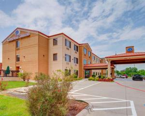 a hotel with a parking lot in front of it at Comfort Suites Lake Ray Hubbard in Rowlett