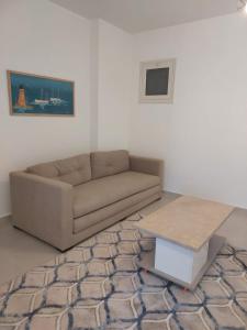 a living room with a couch and a coffee table at Marina Residence New Alamein 2 bedroom apartment in El Alamein