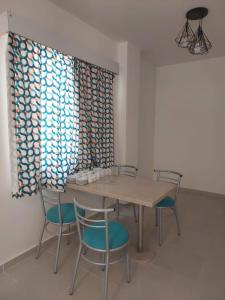 a dining room with a table and chairs at Marina Residence New Alamein 2 bedroom apartment in El Alamein