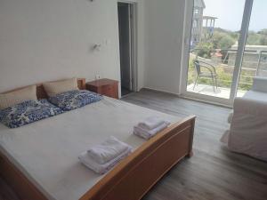 Radovanići的住宿－Sunset Villa Montenegro，一间卧室配有一张大床和毛巾