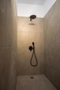 a bathroom with a shower with a shower head at Villa Tranquila Rhodes in Psinthos