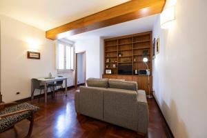 a living room with a couch and a table at Ibernesi 23 - Fori Imperiali in Rome