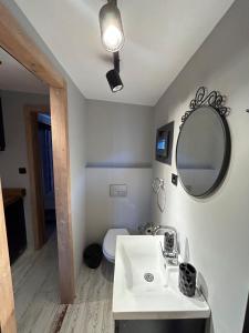 a bathroom with a white sink and a mirror at Likya Garden Life in Gâvurağılı