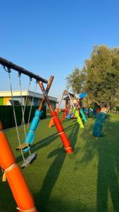 a playground with colorful swings on the grass at The Arkin Iskele in Iskele