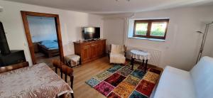 a room with a bedroom with a bed and a table at Apartmán Nelka pri Muránskej Planine in Muránska Dlhá Lúka