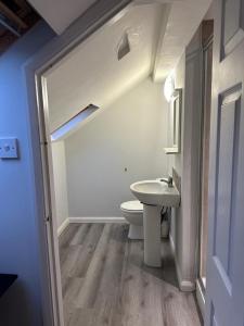 a bathroom with a white toilet and a sink at Ecclesall Suites in Nether Edge