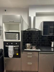 a kitchen with a stove top oven and a microwave at Ecclesall Suites in Nether Edge