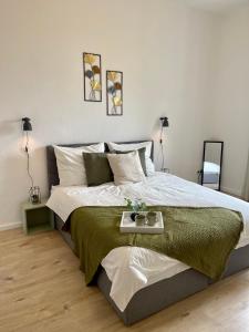 a bedroom with a large bed with a tray on it at Perfekt für 5 - Stylisch & Zentral - Küche in Essen