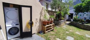 a washing machine next to a house with a door at HOSTEL NAMOR in Ribadeo