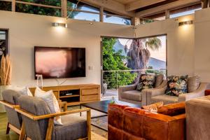 a living room with a large flat screen tv at Lobster Villa in Cape Town