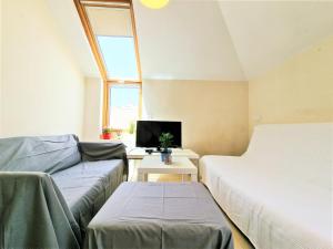 a room with two beds and a couch and a tv at AA Guest - Salinas Paradise Terrace Eco Apartment in Fuengirola