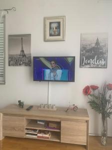 a living room with a flat screen tv on the wall at Apartman S & S in Makarska