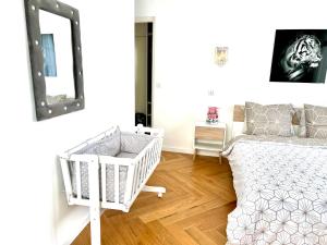 a bedroom with a crib and a mirror at Alexandru Home in Boissy-Saint-Léger