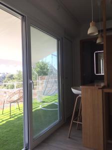 a sliding glass door with a view of a yard at D & A LAND in Alonnisos