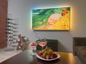 a table with two glasses of wine and a plate of fruit at Bystravilla in Bystrá