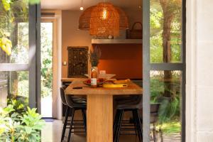a kitchen with a wooden table with chairs around it at Maison d’Etienne in Lacoste +64 photos
