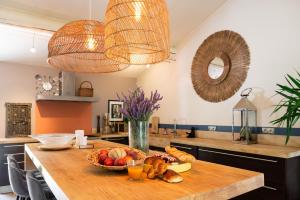 a kitchen with a table with a bowl of fruit at Maison d’Etienne in Lacoste