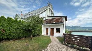 a white house with a fence in front of it at Villa Haškova with 3 bedrooms in Banská Bystrica