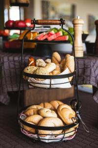 a rack of breads and pastries on a table at Hotel Faaker See Inn by S4Y in Faak am See