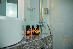two bottles of soap sitting on a counter in a bathroom at Marchica Hotel in Nador
