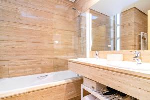 a bathroom with two sinks and a bath tub at Velazquez Suites in Madrid