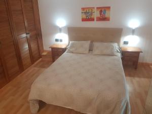 um quarto com uma cama grande e 2 mesas de cabeceira em Medano Loft em El Médano