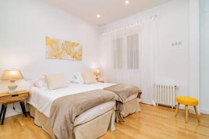 Łóżko lub łóżka w pokoju w obiekcie Juan Bravo Suites