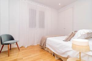 Łóżko lub łóżka w pokoju w obiekcie Juan Bravo Suites