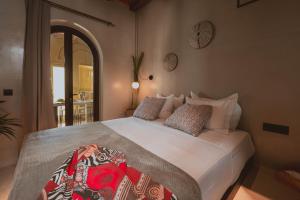 a bedroom with a large white bed with pillows at Legends in Town, by Mykonos High in Mikonos +115 photos