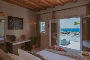 a bedroom with a bed and a view of the ocean at Legends in Town, by Mykonos High in Mikonos