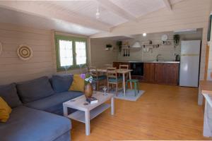 a living room with a blue couch and a table at metaxaki cottage in Mikros Gialos