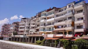 a tall white building with red tile roofs at Evi Apartments 1 in Pomorie